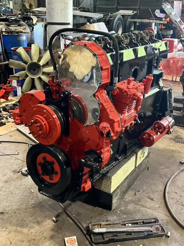 Diesel engine mid-rebuild on a stand in the Mullins Trucking maintenance shop