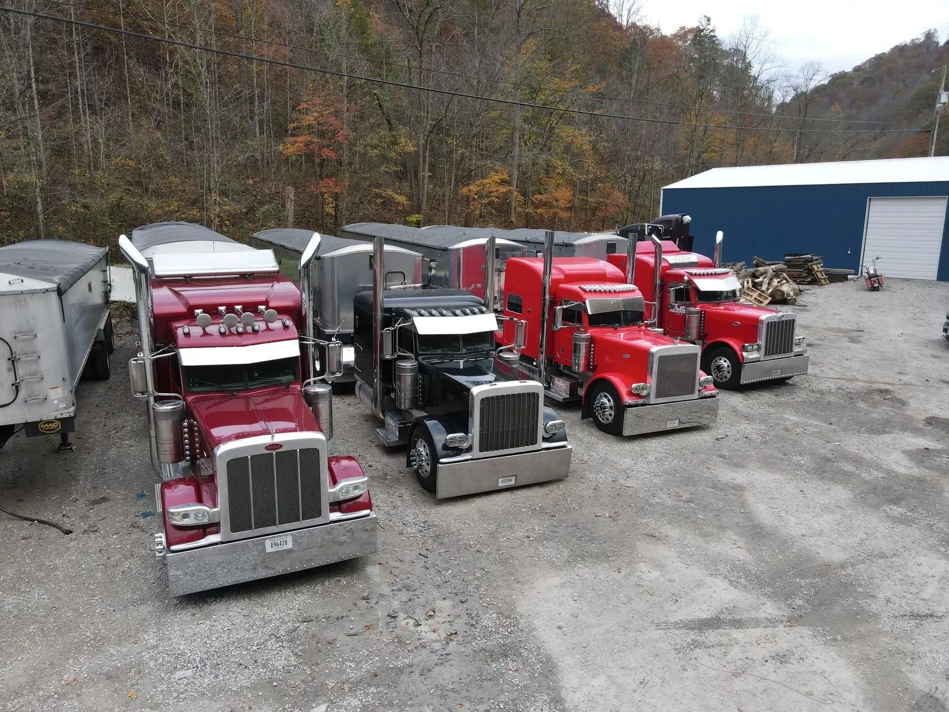 Mullins Trucking fleet of red and black Peterbilts lined up at the Jenkins, KY yard